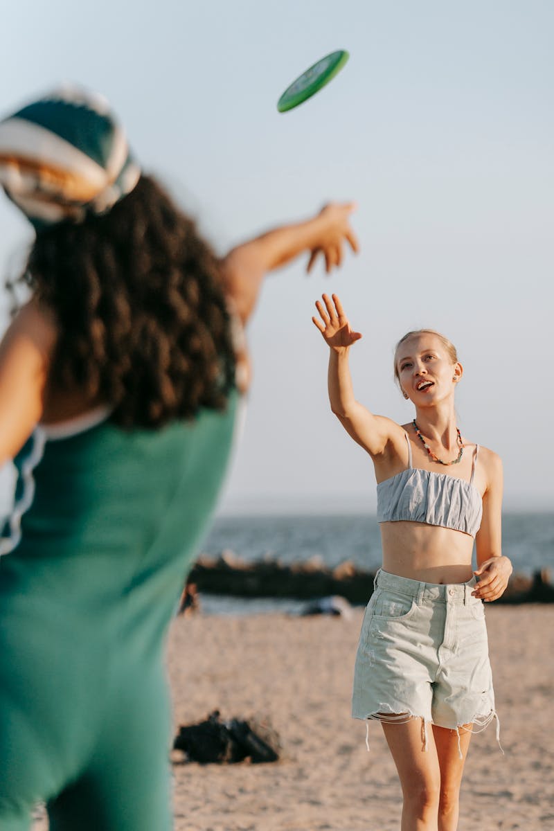 Women Playing Frisbee at the Beach